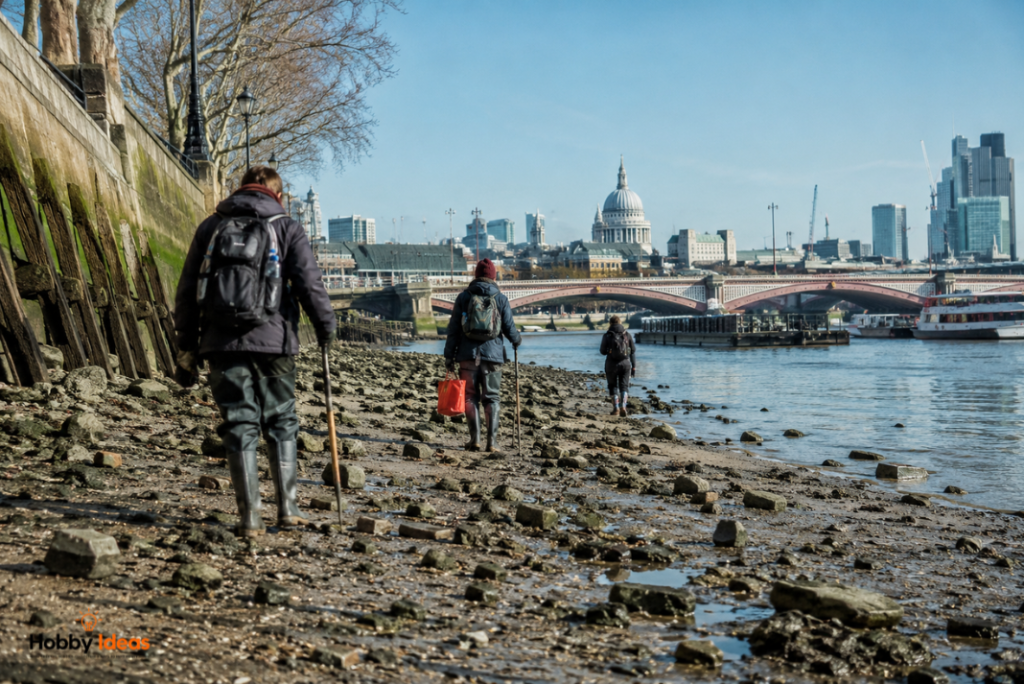Photorealistic image of mudlarks walking along the Thames foreshore in London wearing boots and outdoor gear during low tide